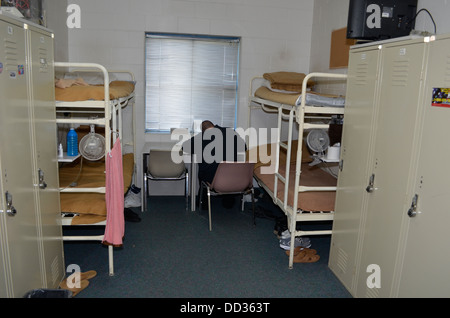 Inmate alone in cell writing a letter. Work release, minimum security prison, Lincoln, Nebraska, USA. Stock Photo