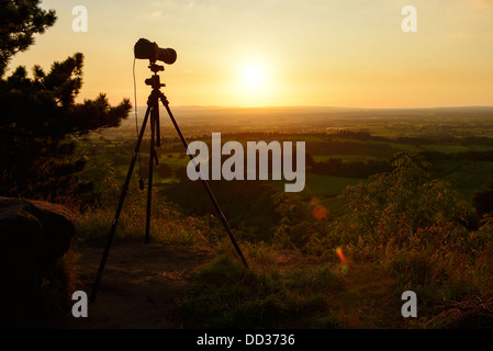 Nikon D800 camera and tripod taking a sunset landscape photograph looking over the Cheshire Plain UK Stock Photo