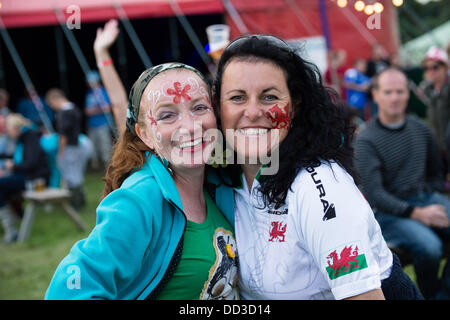 Aberystwyth Wales UK, Saturday 24 August 2013 Two adult women enjoying themselves at a music festival  The second day of the  2013 Big Tribute Festival, Wales's only music festival devoted to covers bands. August Bank Holiday weekend 2013  photo Credit:  keith  morris/Alamy Live News Stock Photo