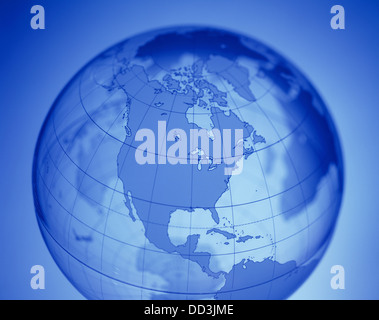 A transparent world globe showing North America. Glowing with blue background Stock Photo