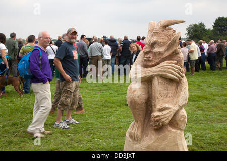 Cheshire Game & Country Fair, UK,  Aug 24 to Aug 26, 2013.  Chainsaw carved figures at the 6th Tabley Cheshire Game & Country Fair held the Showground, Tabley, Knutsford, Cheshire, UK.  An event that attracts hundreds of exhibitors, prestigious championships & competitions and visitors from throughout the United Kingdom.Wood sculpture, sawdust, sculptor, timber, chips, log, professional, working, art, artist, cut, chain saw, artwork made from rough timber log. Stock Photo