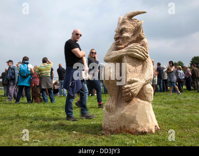 Cheshire Game & Country Fair, UK,  Aug 24 to Aug 26, 2013.  Chainsaw carved figures at the 6th Tabley Cheshire Game & Country Fair held the Showground, Tabley, Knutsford, Cheshire, UK.  An event that attracts hundreds of exhibitors, prestigious championships & competitions and visitors from throughout the United Kingdom. Wood sculpture, sawdust, sculptor, timber, chips, log, professional, working, art, artist, cut, chain saw, artwork made from rough timber log. Stock Photo