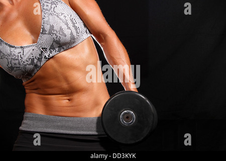 Attractive young woman working out with weights Stock Photo