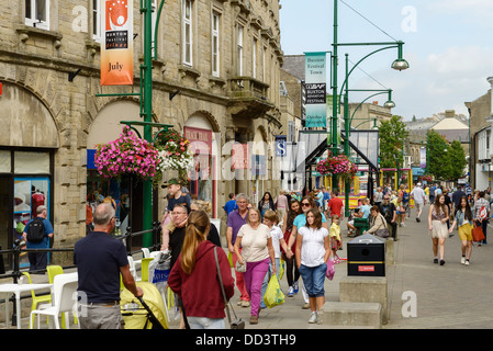 Tourists visitors and shoppers on the main shopping street in Buxton UK Stock Photo
