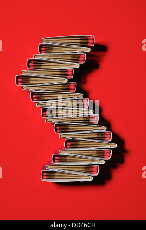Packs of matches together forming a unique pattern. s shape, red background Stock Photo