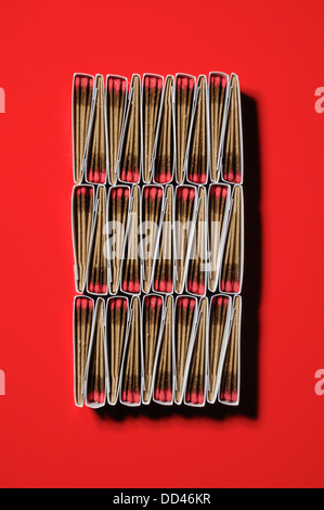 Packs of matches together forming a unique pattern. Rectangular shape, red background Stock Photo