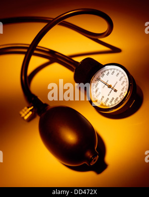 A blood pressure gauge on a orange background Stock Photo