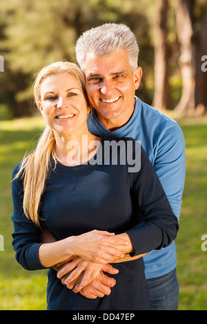 happy middle aged couple hugging outdoors Stock Photo