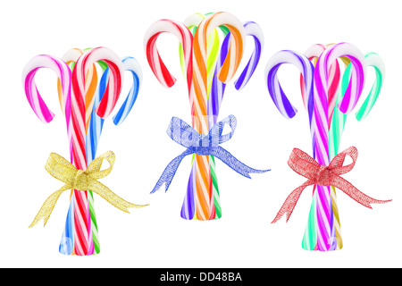 Three Bundles of Colorful Candy Canes On White Background Stock Photo