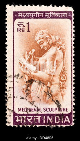 Postage stamp from India depicting a woman writing a letter, 11'th century Chandella Carving. Stock Photo