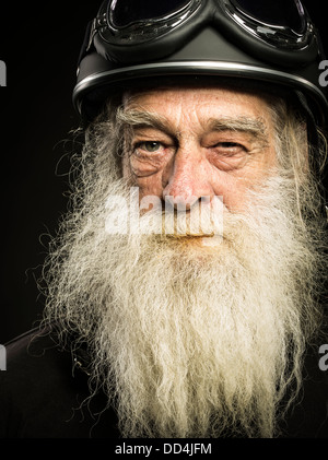 old biker with white beard and helmet Stock Photo