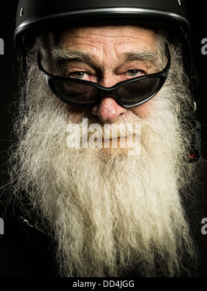 old biker with white beard and helmet Stock Photo