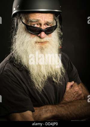 old biker with white beard and helmet Stock Photo