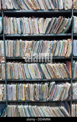 Shelves in a warehouse stuffed with office paperwork, folders and files which have now been transcribed on to digital storage. Stock Photo