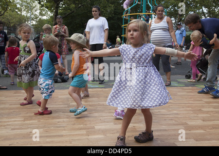 Little girl at a dance festival in her local playground in Brooklyn, NY. Stock Photo