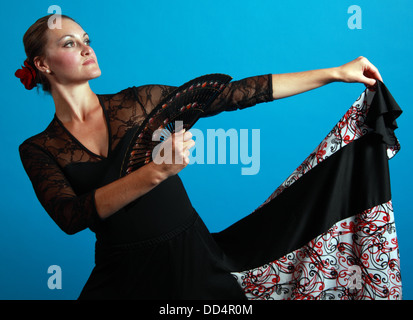 Flamenco dance moves, lady in a black dress with fan