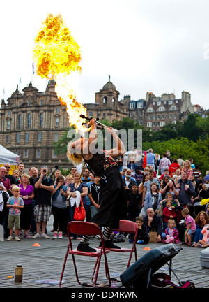 Edinburgh Fringe Festival Japanese street entertainer blowing ball of fire Mound Scotland UK Stock Photo