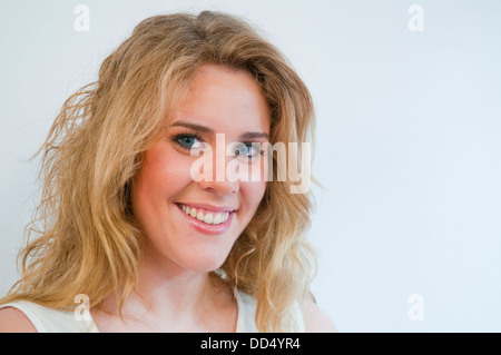 Portrait of young woman smiling and looking at the camera. Close view. Stock Photo