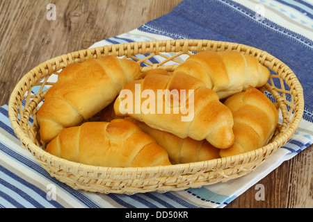 Butter croissants in bread basket, close up Stock Photo