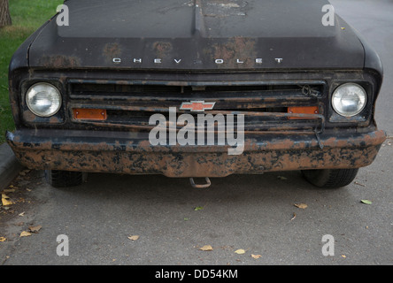 Old Chevrolet car parked on city street Stock Photo