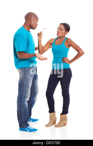 upset African woman showing her boyfriend positive pregnancy test on white background Stock Photo