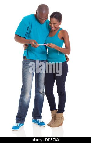 happy young African couple looking at pregnancy test together Stock Photo