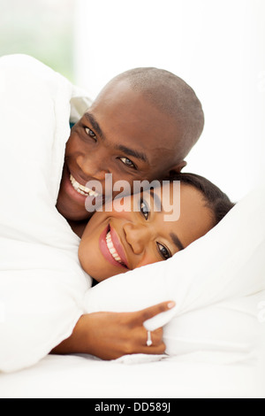 close up portrait of smiling couple sleeping in bed Stock Photo