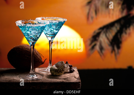 two blue cocktail on beach, sunset, palm tree, coconut Stock Photo