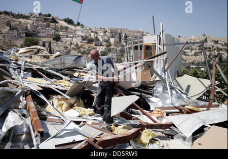 Silwan, Jerusalem, Palestinian Territory. 26th Aug, 2013. Khaled al-Zeer al-Husaini, 39, searches in the rubble of his house in the east Jerusalem Arab neighbourhood of Silwan, August 26, 2013. Al-Husaini is a father of five children live in a cave, which was a stable for animals, after Israeli authorities demolished his own home 3 days ago under the pretext of building without permits Credit:  Saeed Qaq/APA Images/ZUMAPRESS.com/Alamy Live News Stock Photo