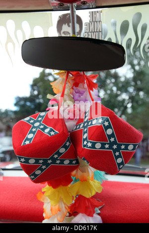 detail of large soft dice hanging from rear view mirror of Classic car, Confederate flag rockabilly sixties style Stock Photo