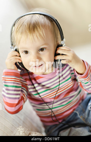 Toddler boy listens to music wearing headphones, Osijek, Croatia, Europe Stock Photo