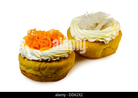 Donuts garnished with white cream and angel hair on white background Stock Photo