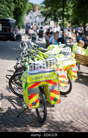 A group of St. John Ambulance cycling paramedics take a well earned rest in the The Groves on a sunny afternoon in Chester. Stock Photo