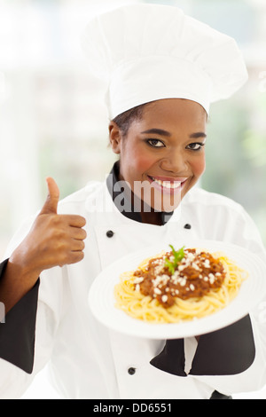 smiling female African American chef giving thumb up Stock Photo