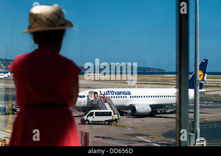 Young Little Girl Looking Out Stationary Lufthansa Airplane Stock Photo