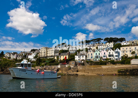 Horizontal view of a moored boat on the river Fowey with Fowey in the background on a beautiful sunny day. Stock Photo