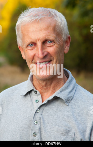 Closeup portrait of happy face of grey-haired old man. Outdoor Stock Photo
