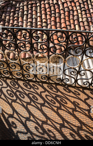 Traditional wrought iron balcony and roof tiles in the village of Dimitsana, Arcadia, Peloponnese, Greece Stock Photo