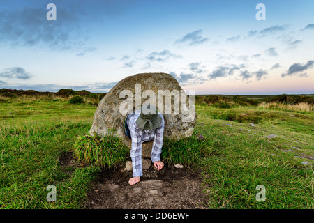 The Men-an-Tol standing stones Near Penzance in Cornwall, local legend says that a person passing through the holed stone can cu Stock Photo