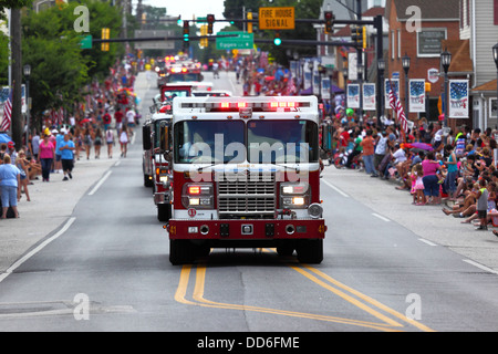 Fire trucks passing through main street while taking part in 4th of July Independence Day parades, Catonsville, Maryland, USA Stock Photo