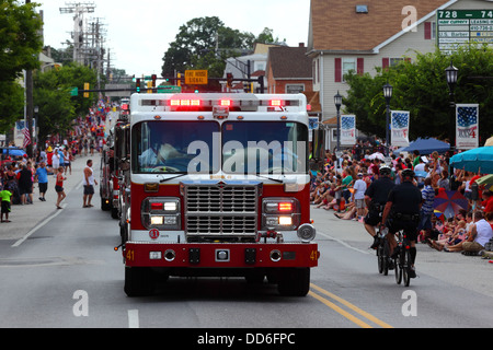 Fire trucks passing through main street while taking part in 4th of July Independence Day parades, Catonsville, Maryland, USA Stock Photo