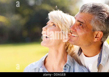 happy middle aged couple bird watching outdoors Stock Photo