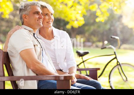 beautiful elegant mid age couple daydreaming retirement outdoors Stock Photo
