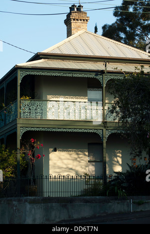 A traditional Victorian Sydney terrace house with verandah and ironwork lacing on balcony, photographed in the late afternoon. Stock Photo