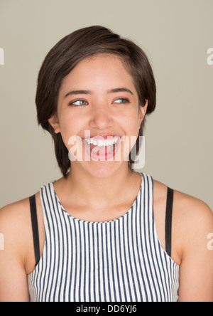 Happy and carefree young woman laughing and looking away
