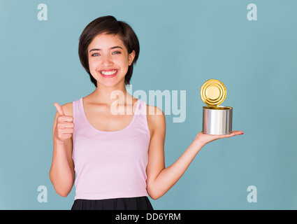 Portrait of proud and confident young multiracial woman in tank top recycling metal can Stock Photo