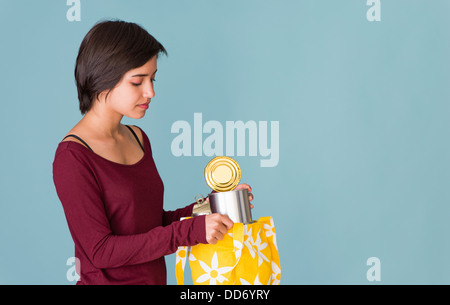 Portrait of young multiracial woman recycling metal cans Stock Photo