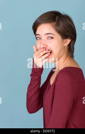 Portrait of young multiracial woman yawning Stock Photo