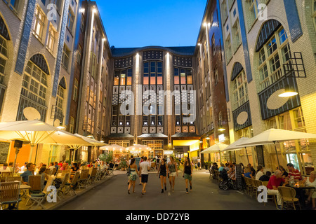 Busy restaurants in the evening at a Hackesche Hof or courtyard at Hackescher Markt in  Mitte Berlin Germany Stock Photo