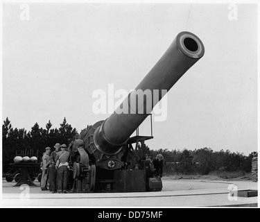 This photograph depicts an 8-inch howitzer artillery gun firing an ...